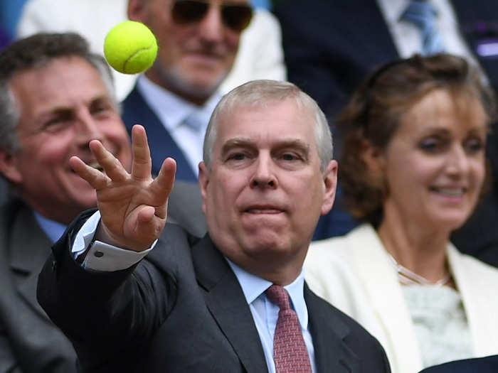 In 2016, Prince Andrew is photographed throwing a tennis ball that landed in the Royal Box during the semi-final match between Rodger Federer and Milos Raonic.