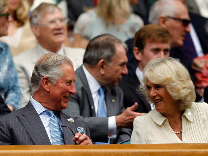 In an adorable moment of their own, Charles and Camilla, Duchess of Cornwall, laugh together at a match featuring Roger Federer in 2012.