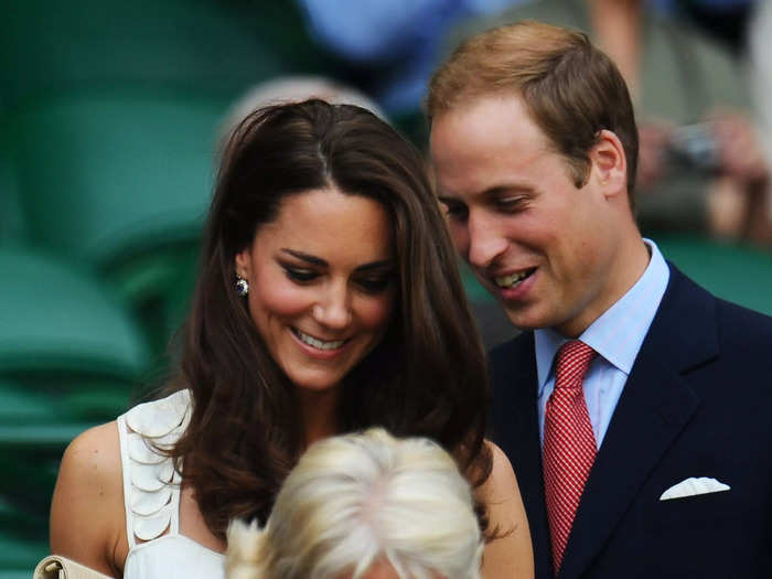 Having just tied the knot months beforehand, Middleton and William share a sweet moment at Wimbledon 2011 while making their way through the stands.