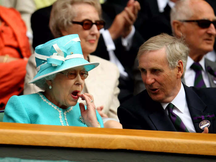 In 2010, the Queen is pictured once again wiping the corner of her mouth while keeping her eyes on Andy Murray playing Jarkko Nieminen at Wimbledon.