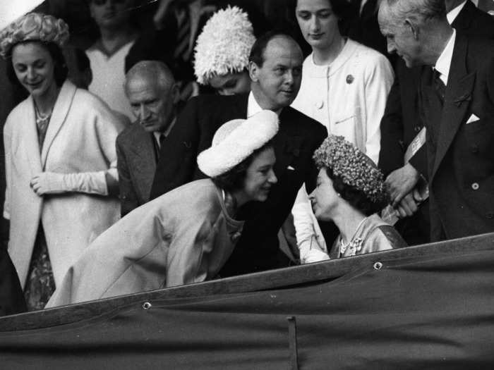 Queen Elizabeth II and Princess Margaret lean in for a chat while at the men