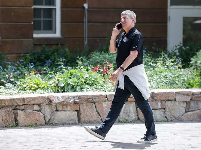 Jeff Shell, CEO of NBCUniversal, takes a call while walking the grounds.