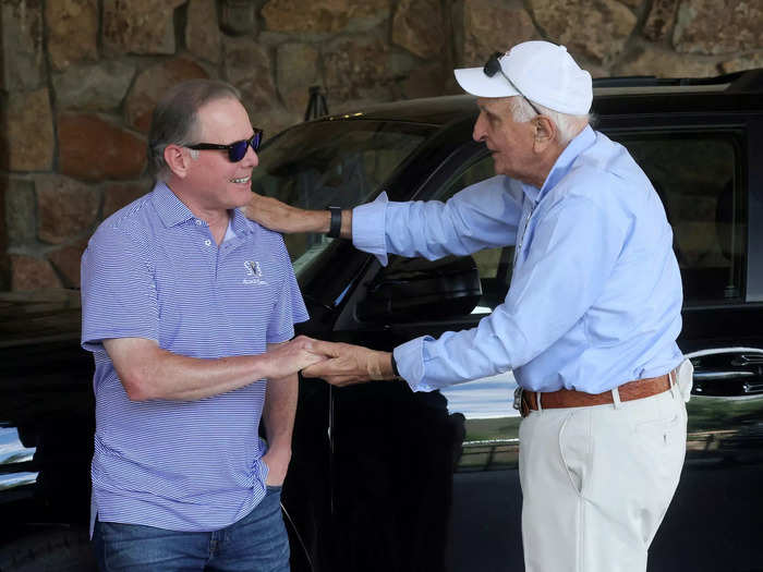 David Zaslav, left, CEO of Warner Bros. Discovery, greets billionaire investor Ken Langone.