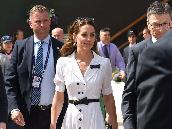 2019: The duchess wore a white button-down dress with an Alexander McQueen belt and accessorized with a matching clutch bag and sunglasses.