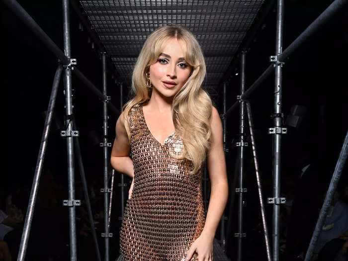 Sabrina Carpenter attended the Paco Rabanne fashion show in a gold, see-through dress.