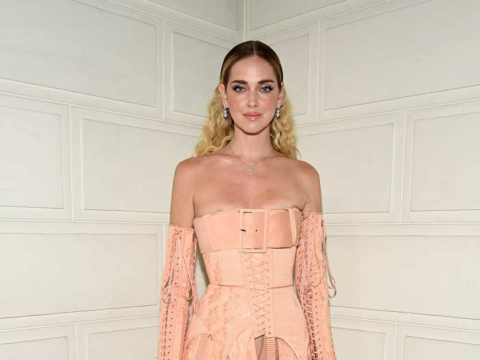 Chiara Ferragni attended the same fashion show in a deconstructed dress with belts hanging from the skirt.