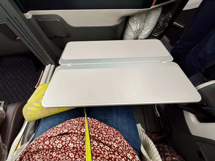 …a large tray table that deploys from the armrest…