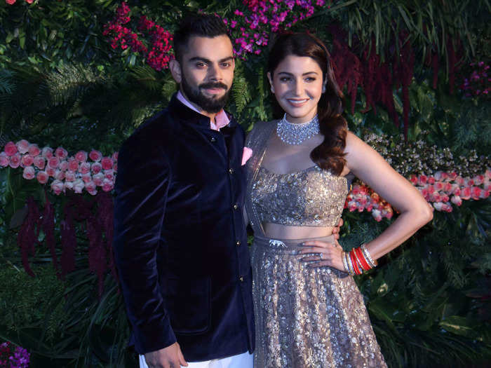 Sharma wore an antique gold lehenga by Sabyasachi for her wedding reception, featuring the designer