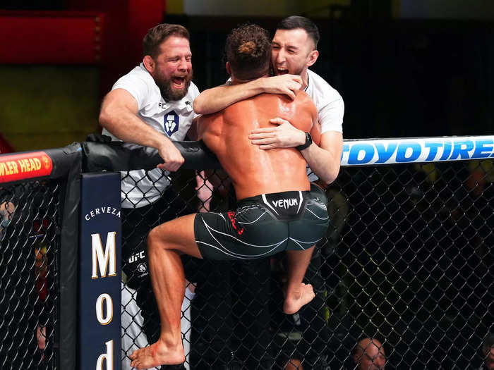 He mounted the fence to celebrate with his team …