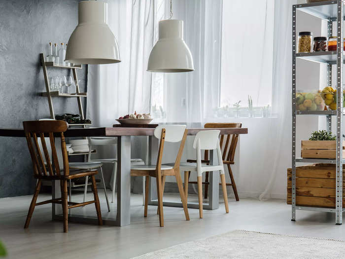 Mismatched dining chairs tend to look more confusing than chic.