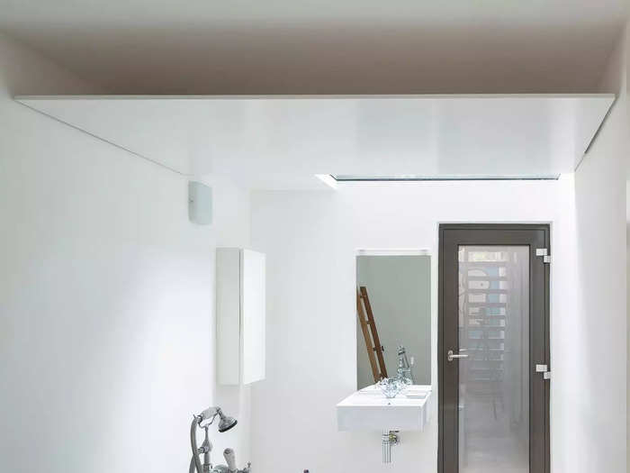 All the way down on the lower ground floor is the polished-looking bathroom, which comes with a standalone tub and a skylight, allowing natural light to stream in.