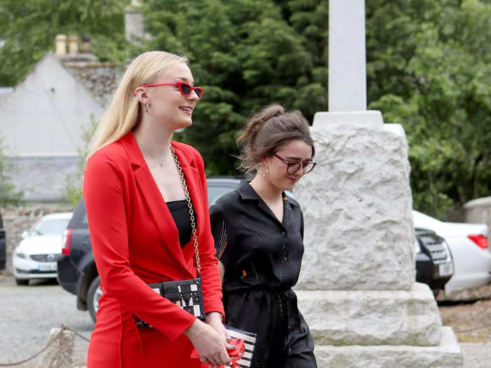 Sophie Turner stood out in a red Louis Vuitton blazer dress at Kit Harington and Rose Leslie