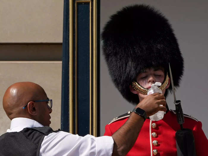 Even a British soldier outside Buckingham Palace took a break to sip some water.