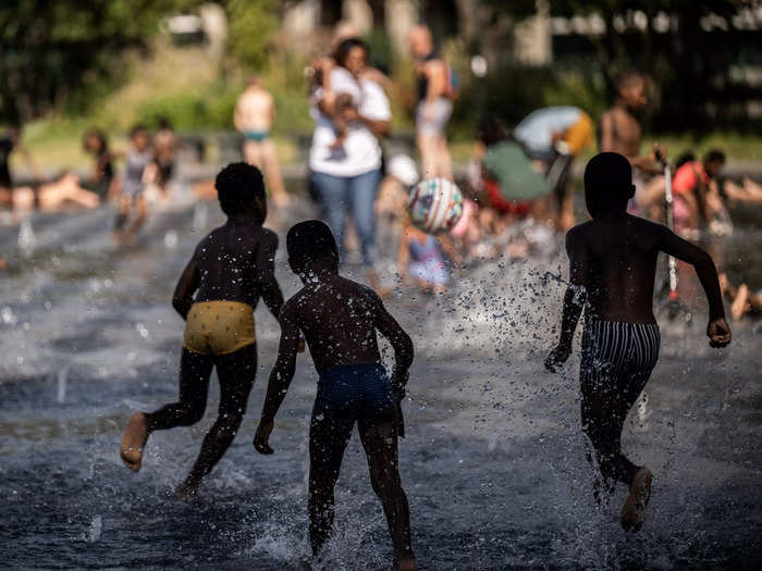 Children in France sought reprieve from the heat in cold fountains.