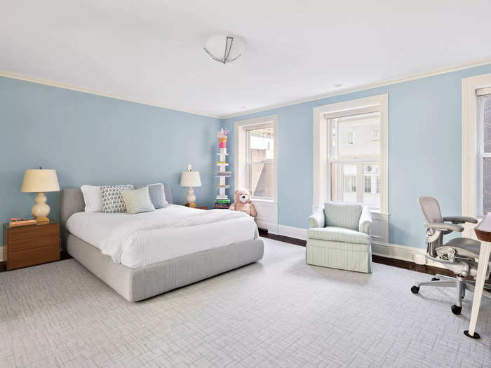 The other bedroom, found across the hall, is colored light blue and mimics the primary bedroom.