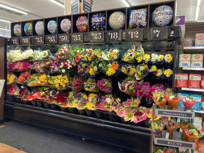 Nearby, a wall of flowers contained bouquets at a variety of price points.