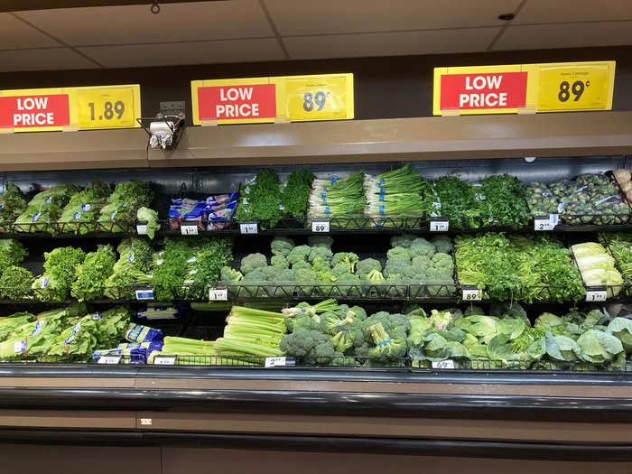 There were more sale signs above the shelves of fresh greens.