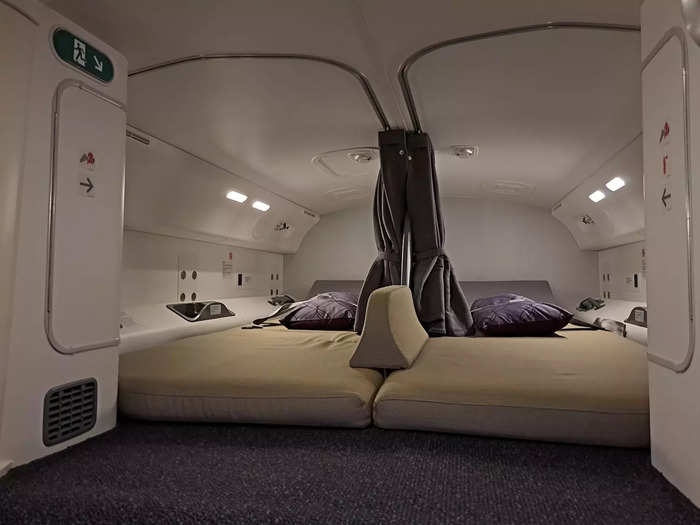 The Boeing 787 compartment has two bunks, each with a private curtain for privacy.