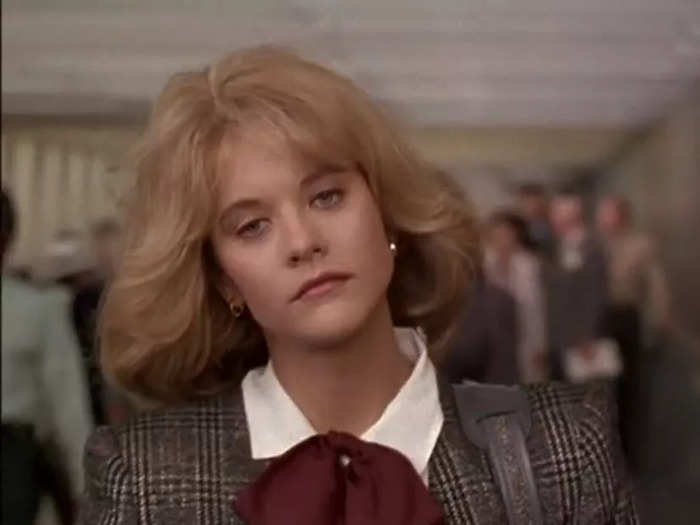 The next time we see Sally, she embodies 1980s fashion in a tweed blazer, white shirt, and red necktie.