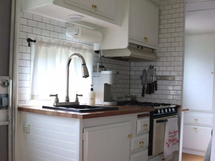 The renovated kitchen includes a refrigerator, microwave, stove, and sink.