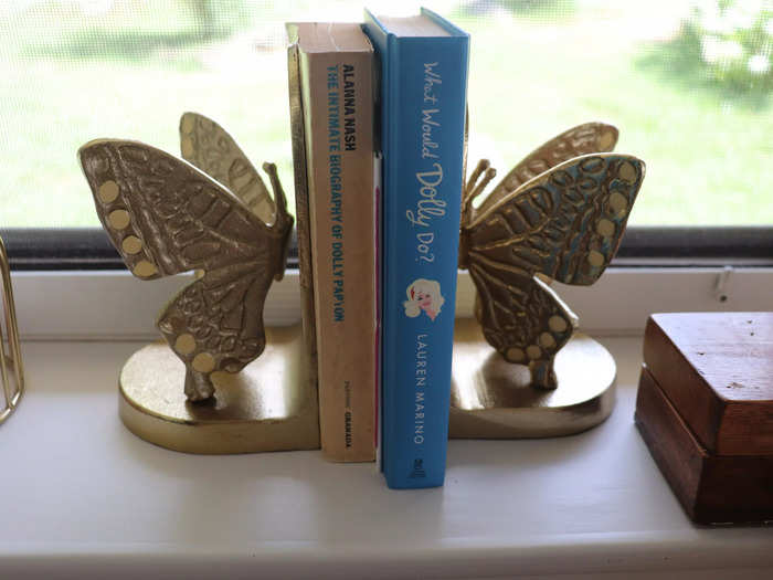 Butterfly bookends hold copies of "What Would Dolly Do?" and "The Intimate Biography of Dolly Parton."