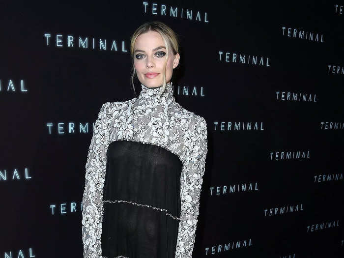 Continuing her love of long-sleeve dresses, Robbie attended a 2018 premiere wearing a midi dress with a white floral high-neck and sleeves, and a black sheer body.