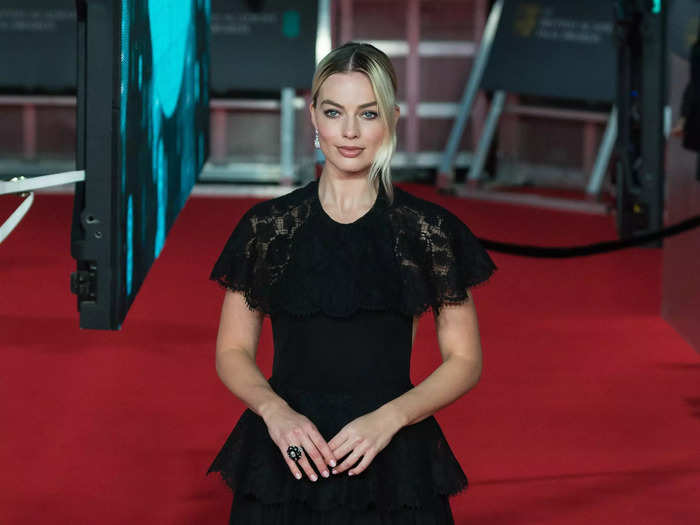 Margot Robbie attended the 2020 EE British Academy Film Awards ceremony in an elegant peplum gown with a lace panel over her chest and shoulders.