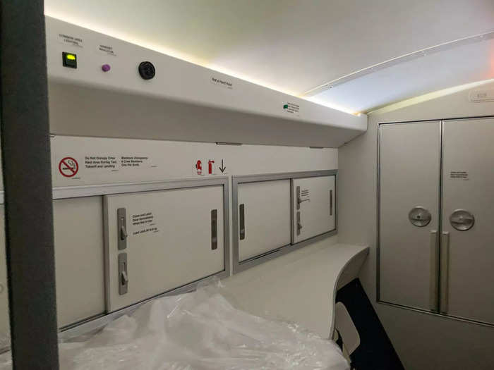 Once out of the bed, I moved to the front of the room, where there was another mirror and storage for flight attendants to stash their personal belongings.