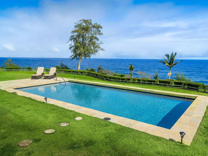 A pool in the backyard overlooks the ocean.
