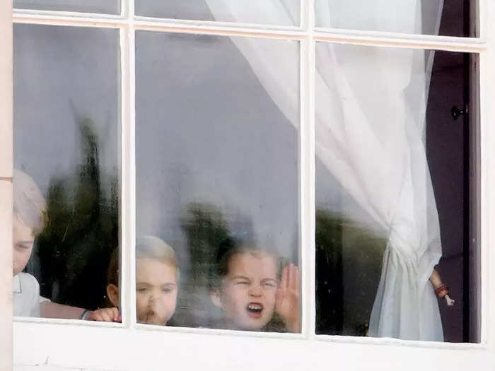 Two years later, the older siblings had a young Prince Louis to keep them company while pulling funny faces out of the windows of Buckingham Palace.