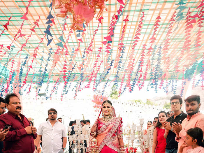 Perhaps the most personal aspect of the nuptials was the lehenga that Simran wore to their wedding ceremony. The hot pink outfit was embroidered with intricate gold flowers, birds, and geometric motifs.