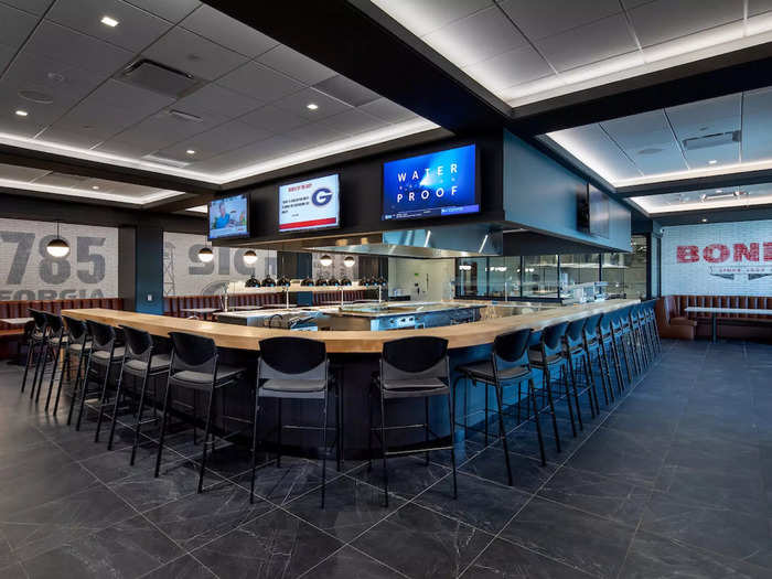 The dining space and demonstration kitchen look like a high-end sports bar.
