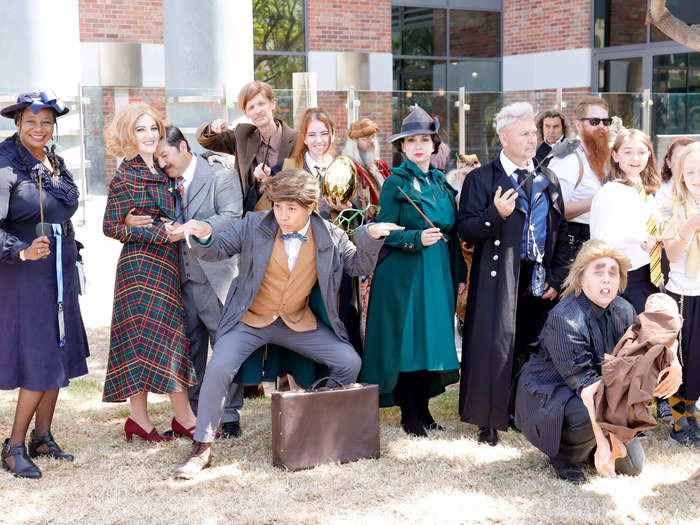 A group of cosplayers dressed as characters from the "Harry Potter" and "Fantastic Beasts" movies, including Newt Scamander, Gellert Grindelwald, and Peter Pettigrew.