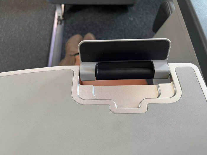 …and a large tray table with a stand for a smartphone.