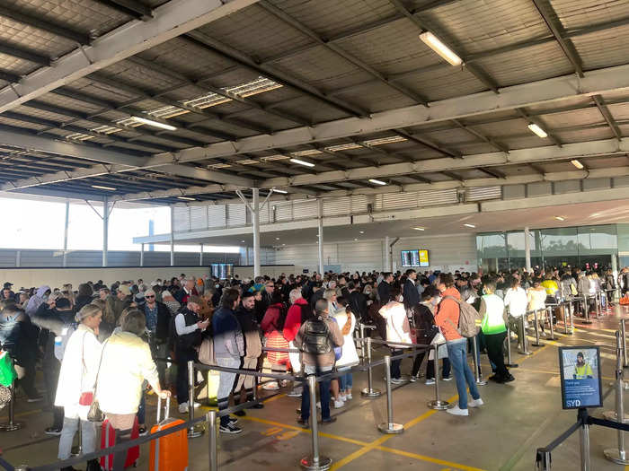 Photos also show passengers lining up in what one Twitter user called a "shed" located next to the terminal.