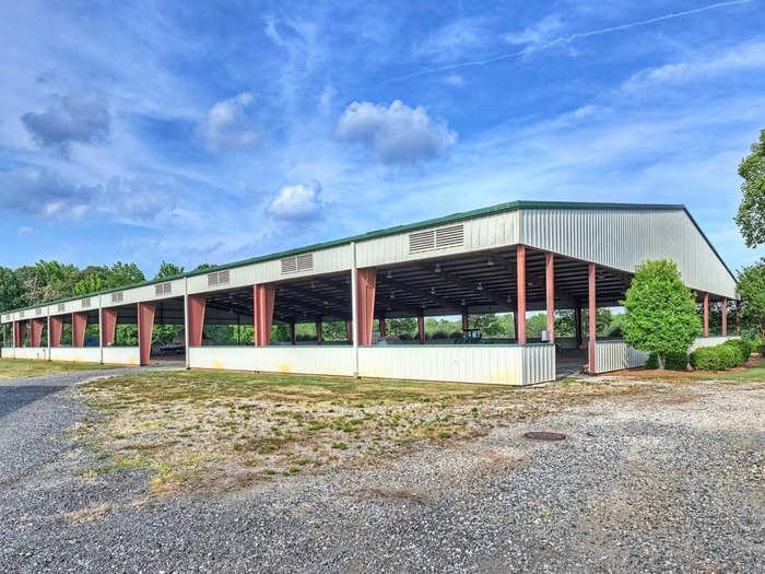 There is also a lighted and enclosed covered horse arena with a viewing area that sits on nearly an acre of land.