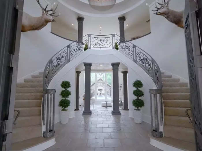 Entering the main house, there is a grand entrance with stairs to the second level.