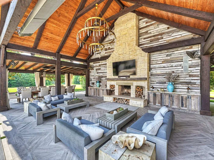 Another view of the outdoor TV area during the daytime. You can see a second dining area in the background.