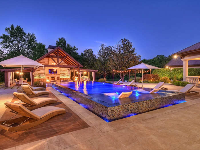 The house has a vanishing-edge pool with a pool house and cabana with plenty of lighting for some nighttime swims or outdoor get-togethers.