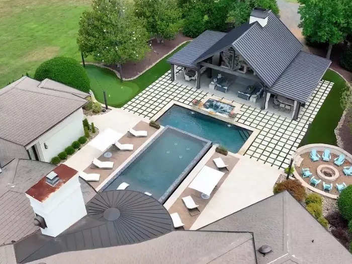 Here is an aerial view of the backyard, showing the pools, hot tub, and a putting green off to the left.