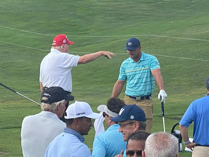 On the range, Trump warmed up with Bryson DeChambeau, who was one of his playing partners for the day.