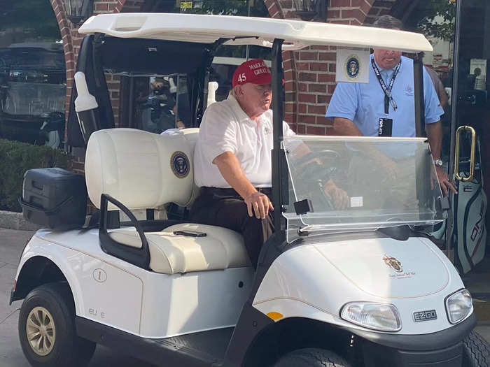 Trump began his day at the course with a trip to the driving range. Note the presidential seal and No. 1 on his cart.