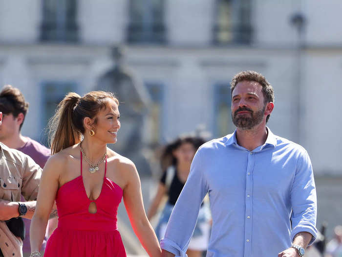 Lopez brought a pop of color to the French capital in a berry-colored halterneck midi dress and a matching bag.