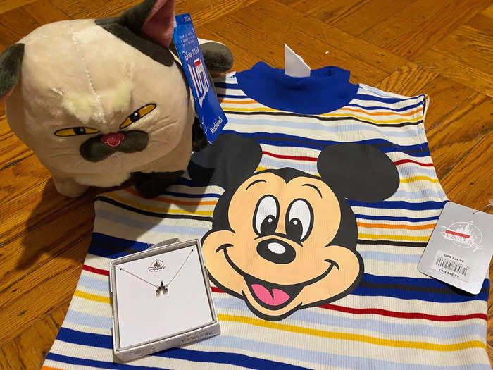 I bought four items — a "Luca" plush, Mickey Mouse shirt, castle necklace, and reusable bag — for $55. At full price, the items would have cost almost $78.