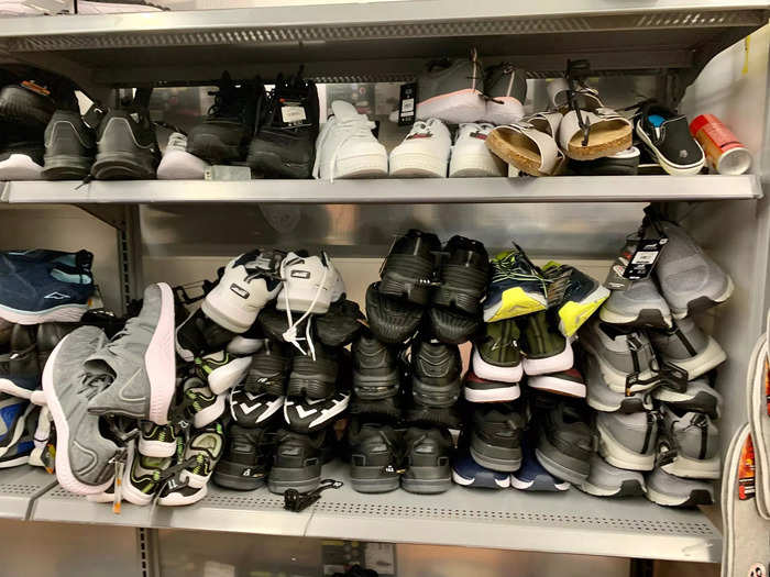 Paris of shoes were stacked up in large piles and falling off shelves.