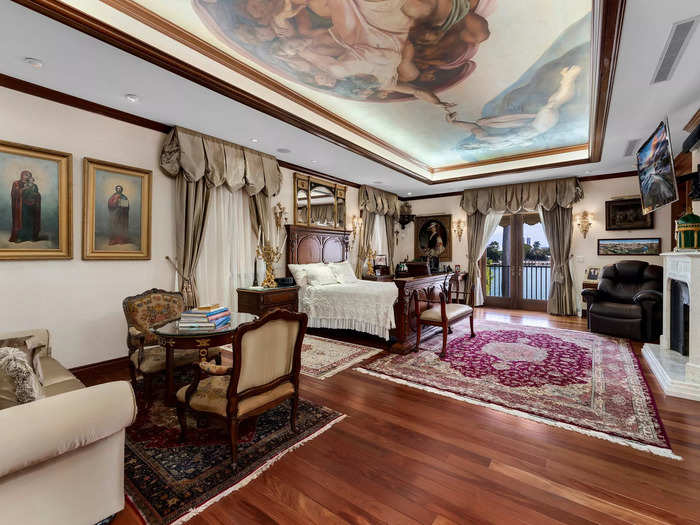 It has five bedrooms, including this one with a ceiling mural...