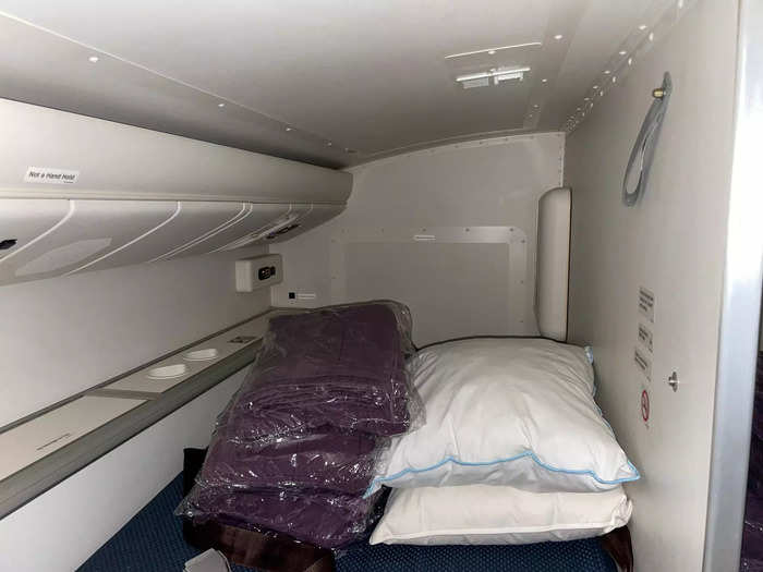 Inside the sleeping cubby, I saw two sets of blankets and pillows, which looked similar to the ones I received in my business-class seat. I thought the mattress on the bed looked comfy enough for a decent nap.