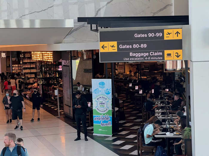 At the bottom of the escalator on the righthand side of the terminal, passengers will either head straight for gates 90-98 or left for gates 80-89.