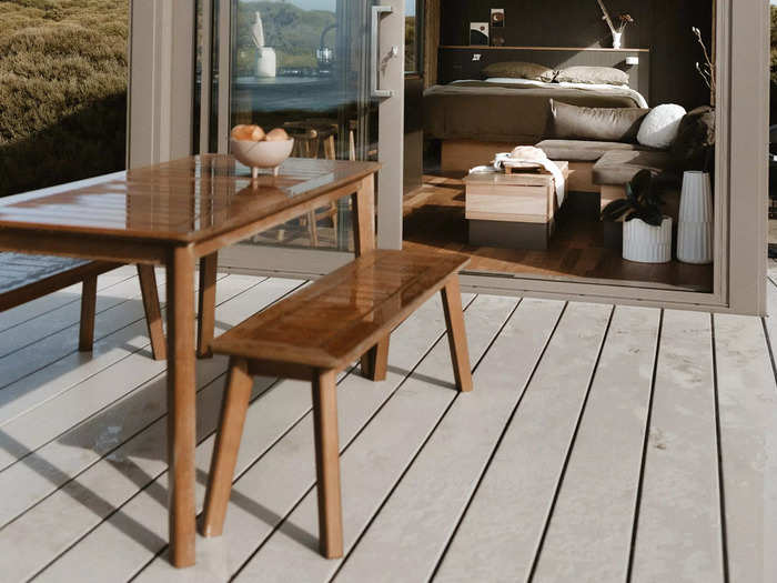 The cabin has its own deck and outdoor seating, perfect for enjoying sunsets over the water.