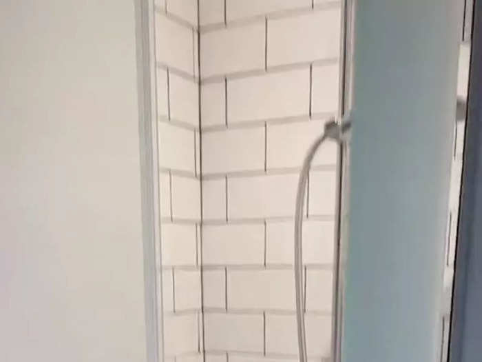 The TikToker said she uses her shower to double up as suitcase storage.